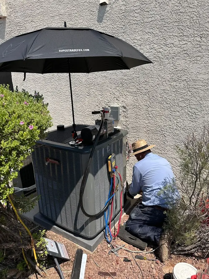 HVAC technician performing outdoor AC maintenance in Shiloh