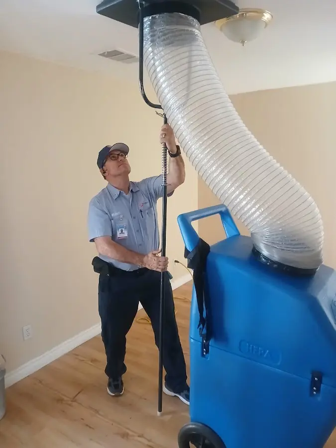 Furnace Tune-Up technician using HEPA equipment in Shiloh